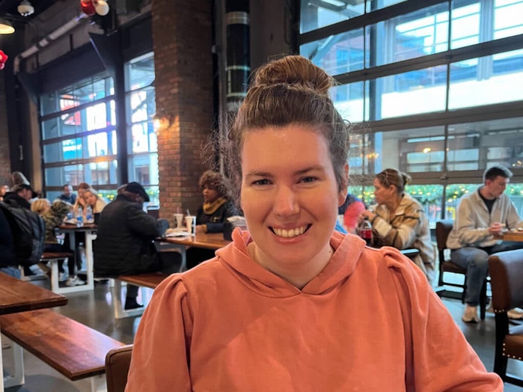 The author, Elizabeth Demolat smiling for a photo at Assembly Food Hall