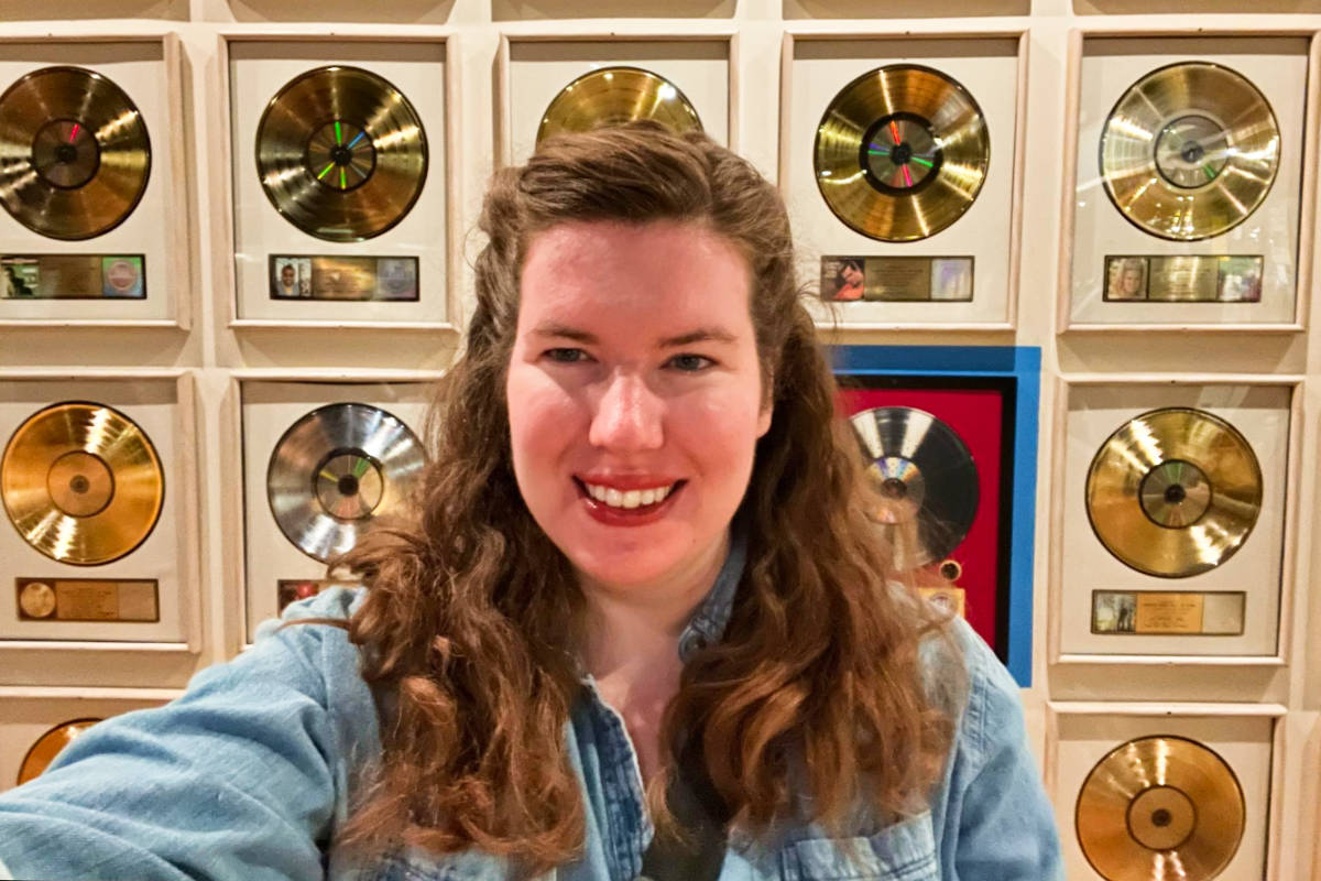 The author, Elizabeth Demolat, posing in front of the displays at the Country Music Hall of Fame