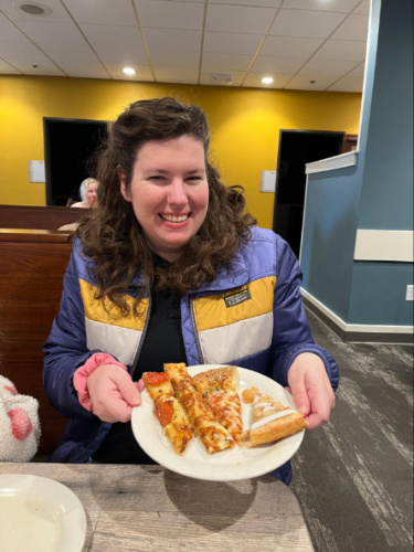 The author Elizabeth showing her plate with variety of pizza at Pizza Ranch