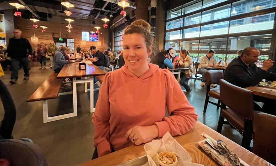 The author smiling for a photo inside the Assembly Food Hall