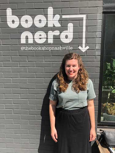 Elizabeth Demolat smiling for a photo outside the Bookshop Nashville
