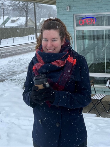 Elizabeth Demolat holding a cup of coffee during winter season in Nashville