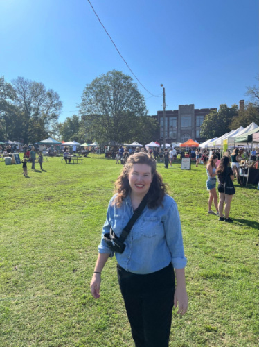 The author Elizabeth Demolat smiling for a photo at the Richland Park Farmer’s Market