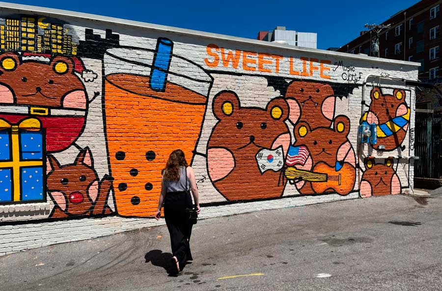 The author walking around Elliston Place and a colorful mural