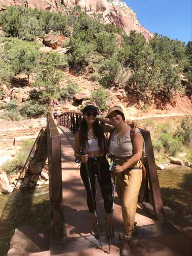 The author with her friend on a bridge at the start of Emerald Pools Trail