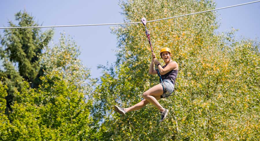 A man enjoying the zipline above the trees in Empower Adventure Tampa Bay