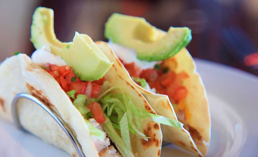 Close up view of a Baja fish tacos with avocado