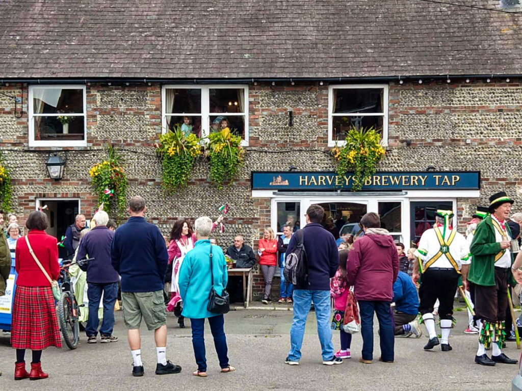The crowd watching the English folk dance performance outside a pub