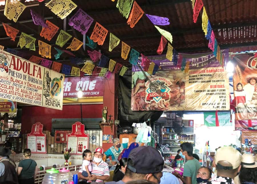 View inside the busy local market with colorful buntings above