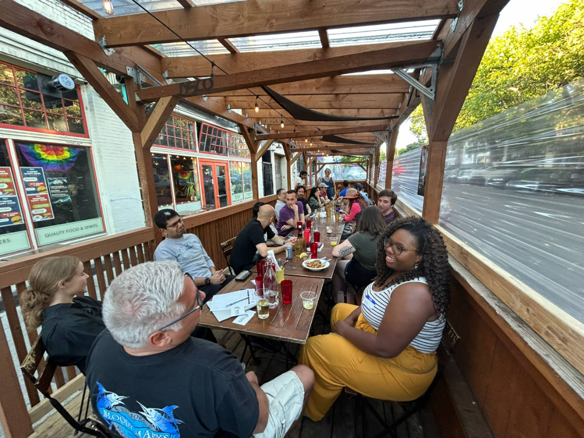 A long table with people who attended the recent Recent Seattle Travel Community Meetup