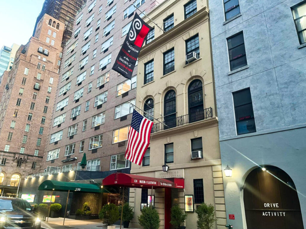 The US flag outside the building of The Museum of Illustration