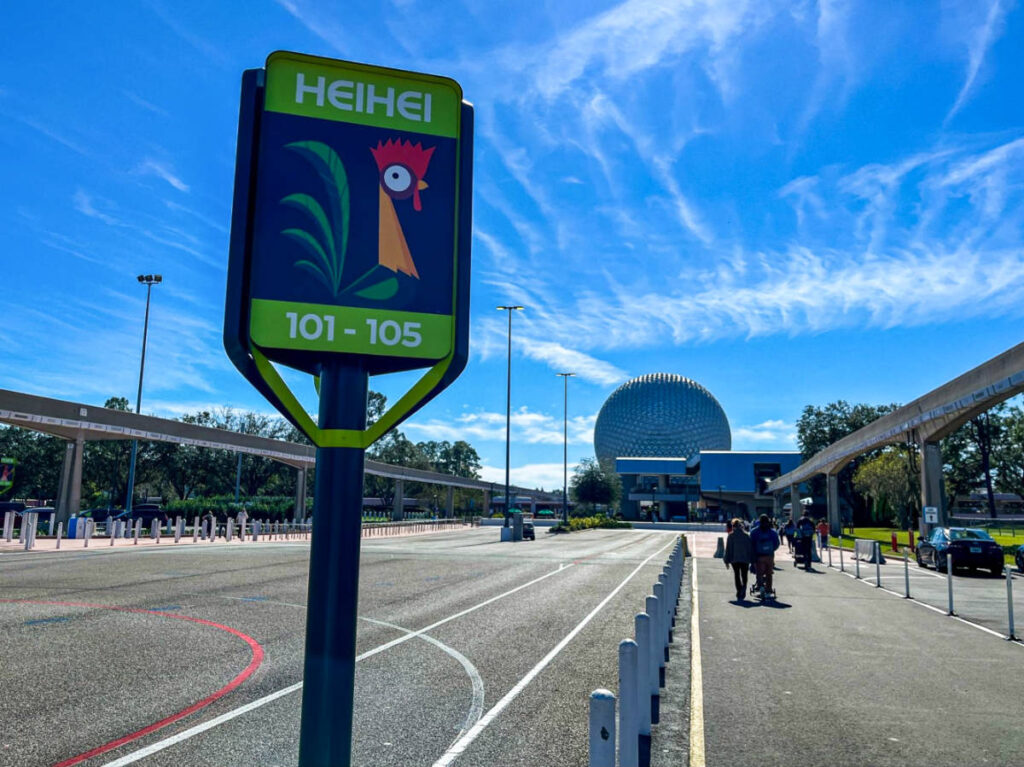 A parking lot signage with a character of Hei Hei at Epcot