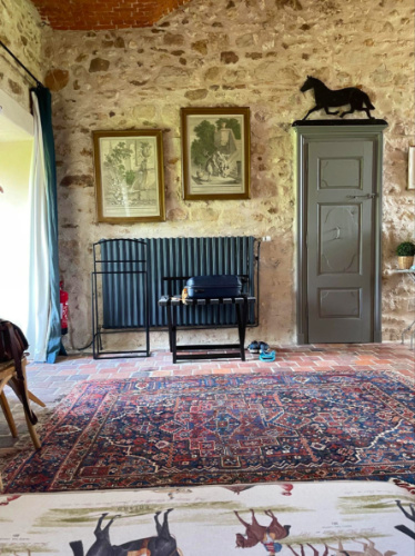 Equestrian-themed room with large rug and horse decor at Château de Fleury