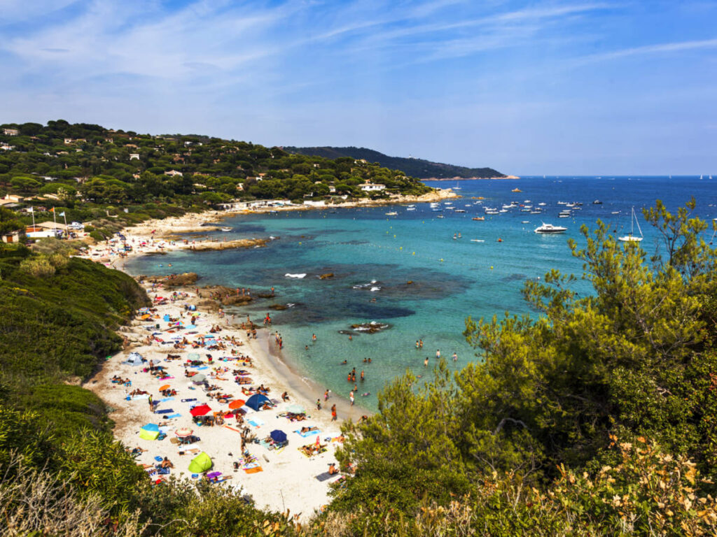 Aerial view of the people chilling at the Escalet Beach, seen from above the lush mountains