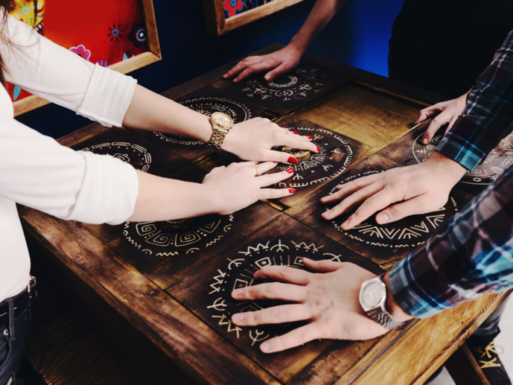 A group trying to move pieces of the Mexican style game to escape the room
