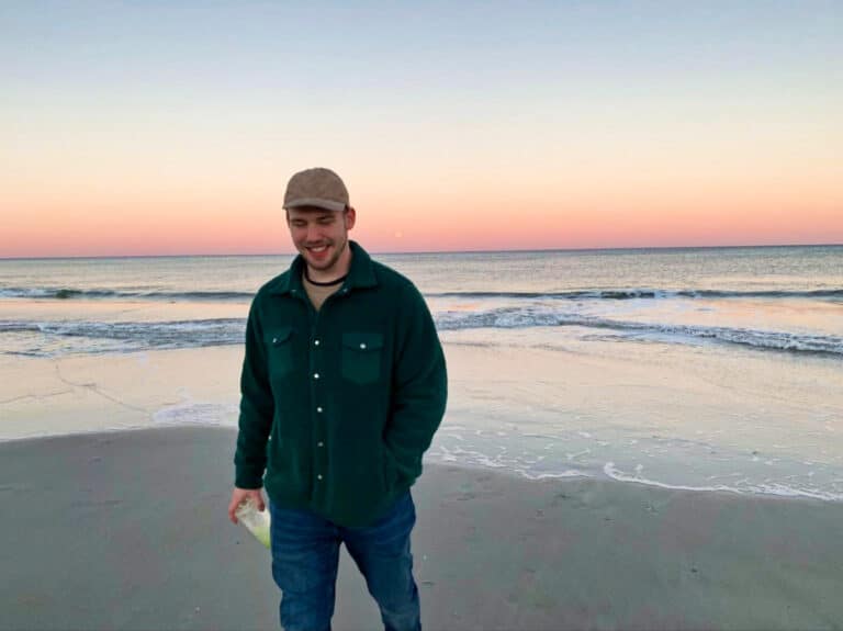 The author Ethan Thoren, posing at Jacksonville Beach during sunset