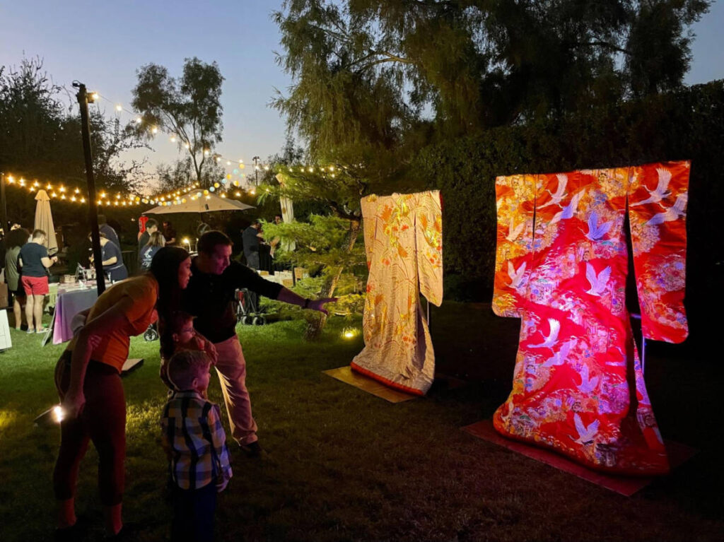 A family looking at the traditional kimonos displayed in Japanese Friendship Garden
