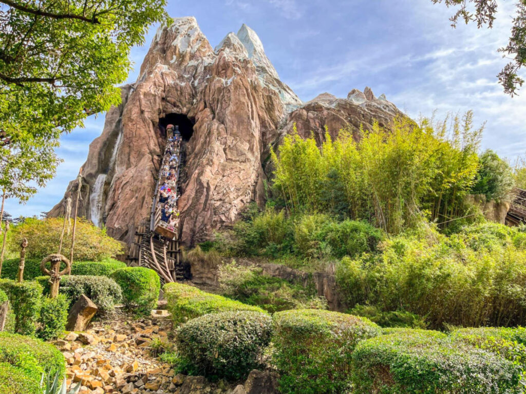 View of Expedition Everest, the iconic mountain at Animal Kingdom, with people riding the rollercoaster