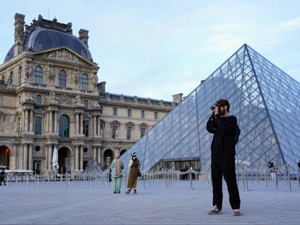Michael taking photos outside the Louvre Museum