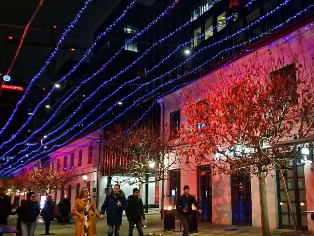 People walking in Fabryka Norblina at night
