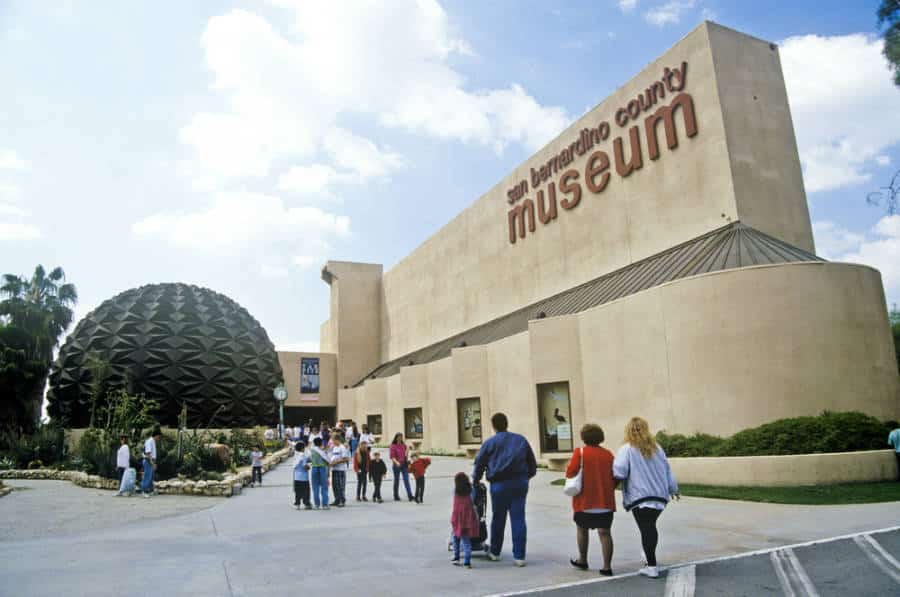 People walking around outside the San Bernardino County Museum