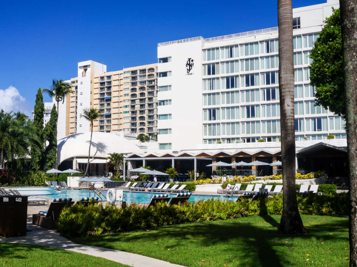 The Fairmont El San Juan Hotel building with the pool area