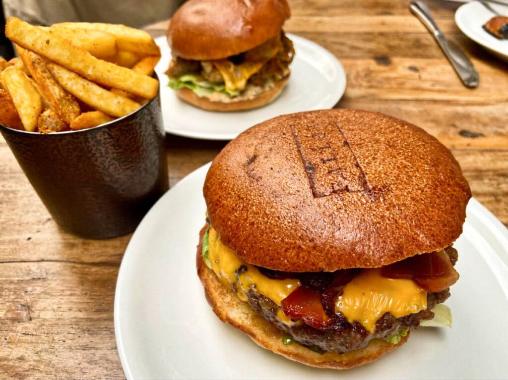 Closeup look of the mouthwatering Fallow Burgers and a bucket of fries