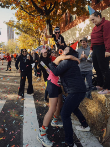 Family hugging a runner on the NYC Marathon