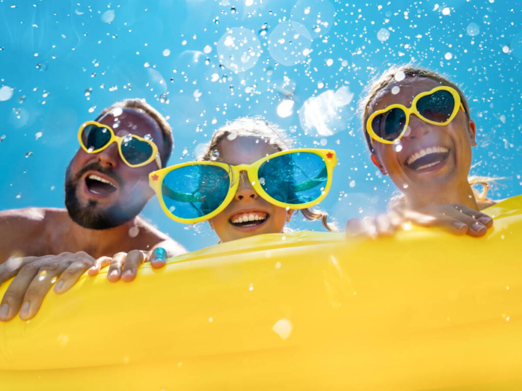 A family with yellow framed glasses on the pool