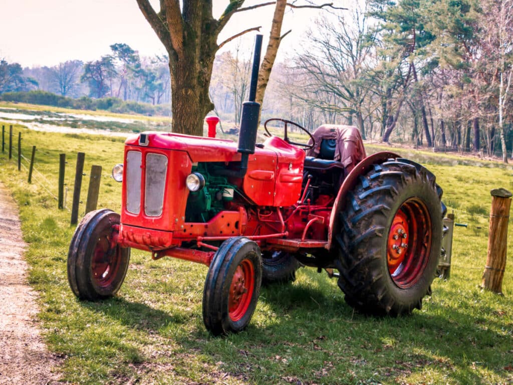 An old red tractor in a farm