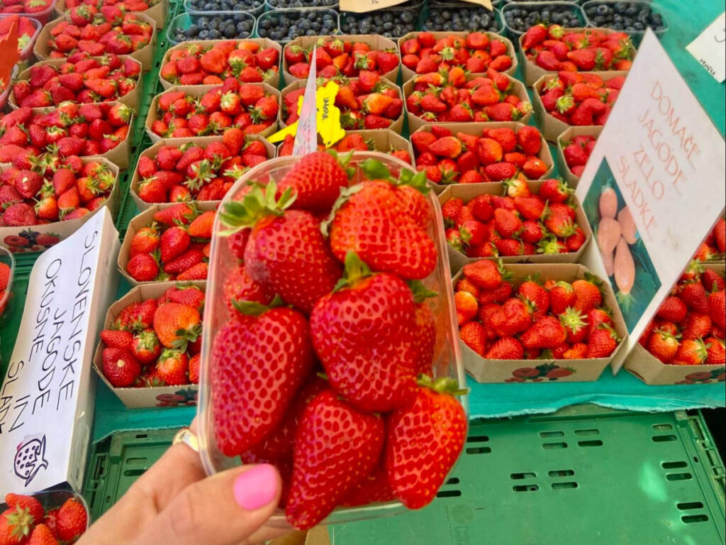 Holding a box of strawberries at the local Farmer’s Market in Ljubljana