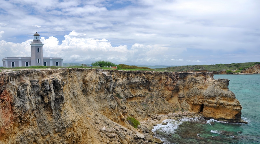 View of a lighthouse on a cliff above the sea