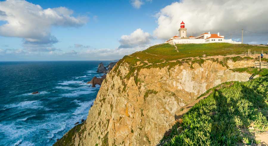 The Faro del Cabo de la Roca on a cliff from afar