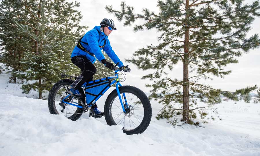 A man riding his fat tire bike during winter in Breckenridge