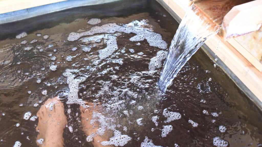 View of the feet soaking under the hot spring