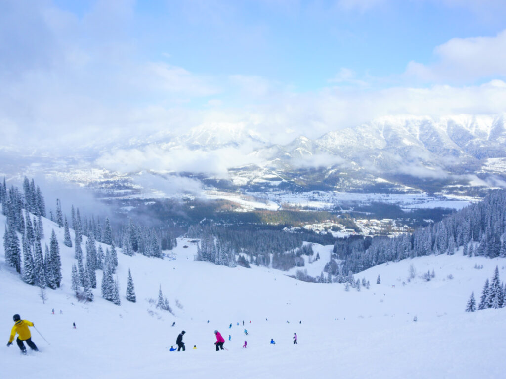 View of Fernie Alpine Resort with snow-covered slopes with people skiing