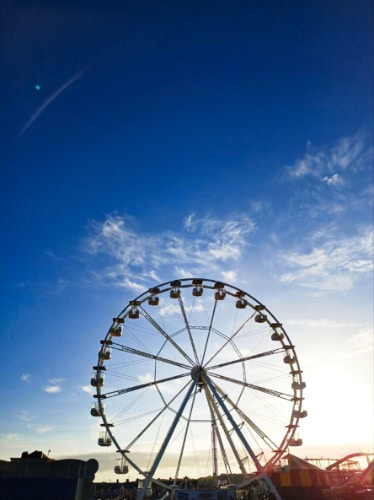 View of the giant Ferris wheel with a clear blue sky in the background