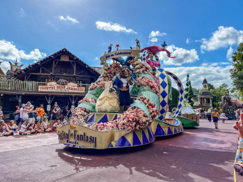 Belle and the beast during the Festival of Fantasy parade