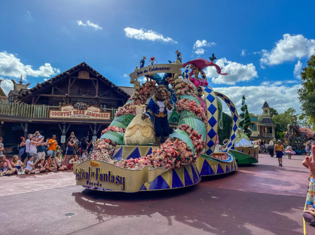 Belle and Beast in a float, part of the Festival of Fantasy Parade.