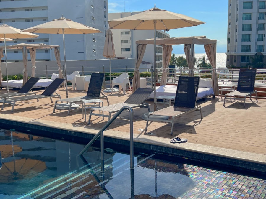 View of pool lounge chairs in Fiesta Inn La Isla Puerto Vallarta