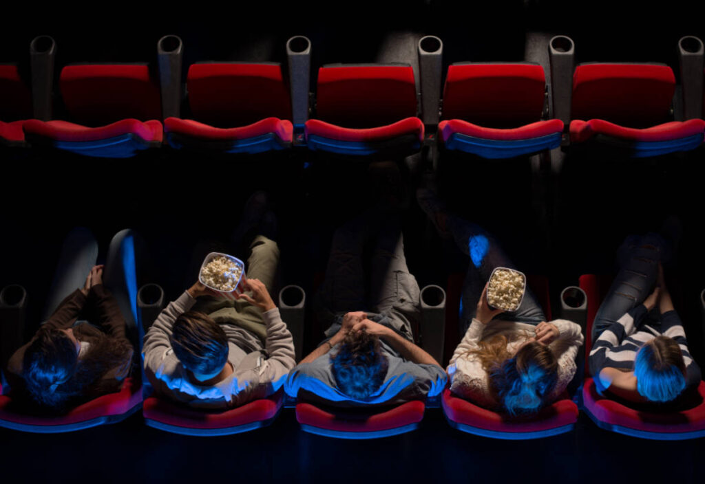 A group of friends watching a movie on a theater in Milwaukee