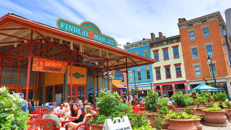 View of the colorful buildings and people eating outdoors at Findlay Market