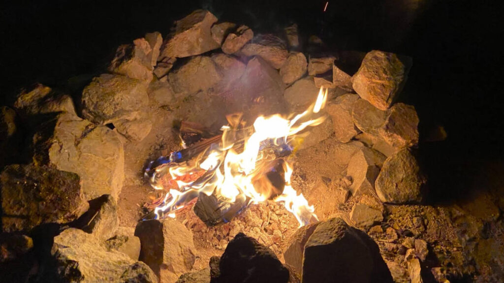 A fire ring at night in Timothy Lake