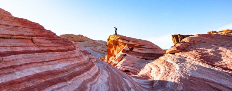 A hiker on top of the Fire Wave in Valley of Fire State Park