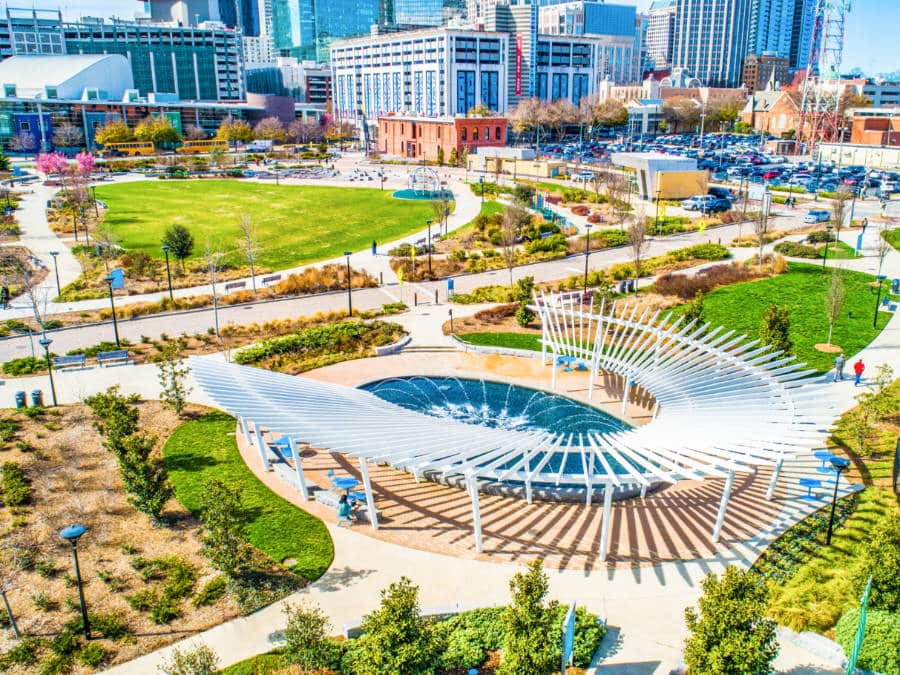 Aerial view of the waterpark surrounded by seating area and buildings in First Ward Park