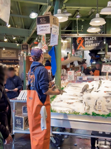 The people at the fish market in Pike Place Market