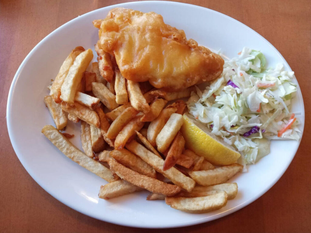A fish and chips with a salad on the side served at Dave’s