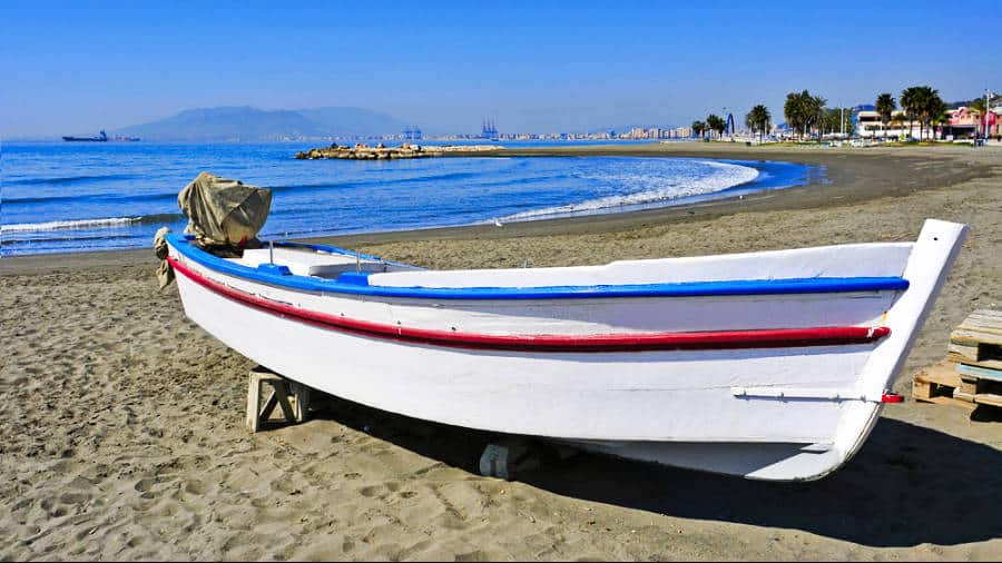 A fishing boat on the shoreline of Pedregalejo Beach