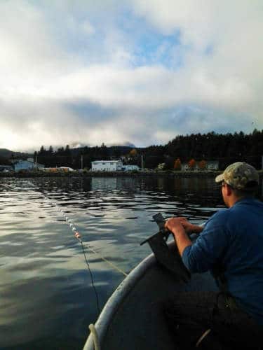 A man enjoying his day, fishing on a lake