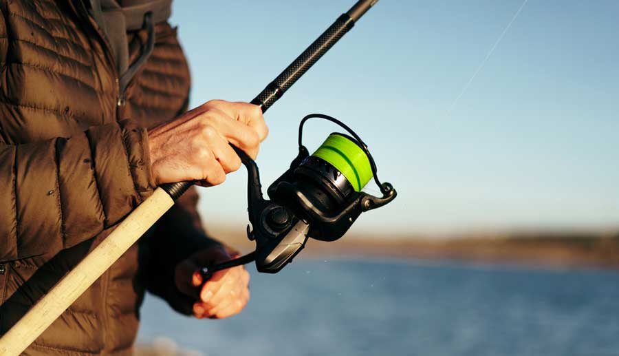 View of a man holding a fishing rod